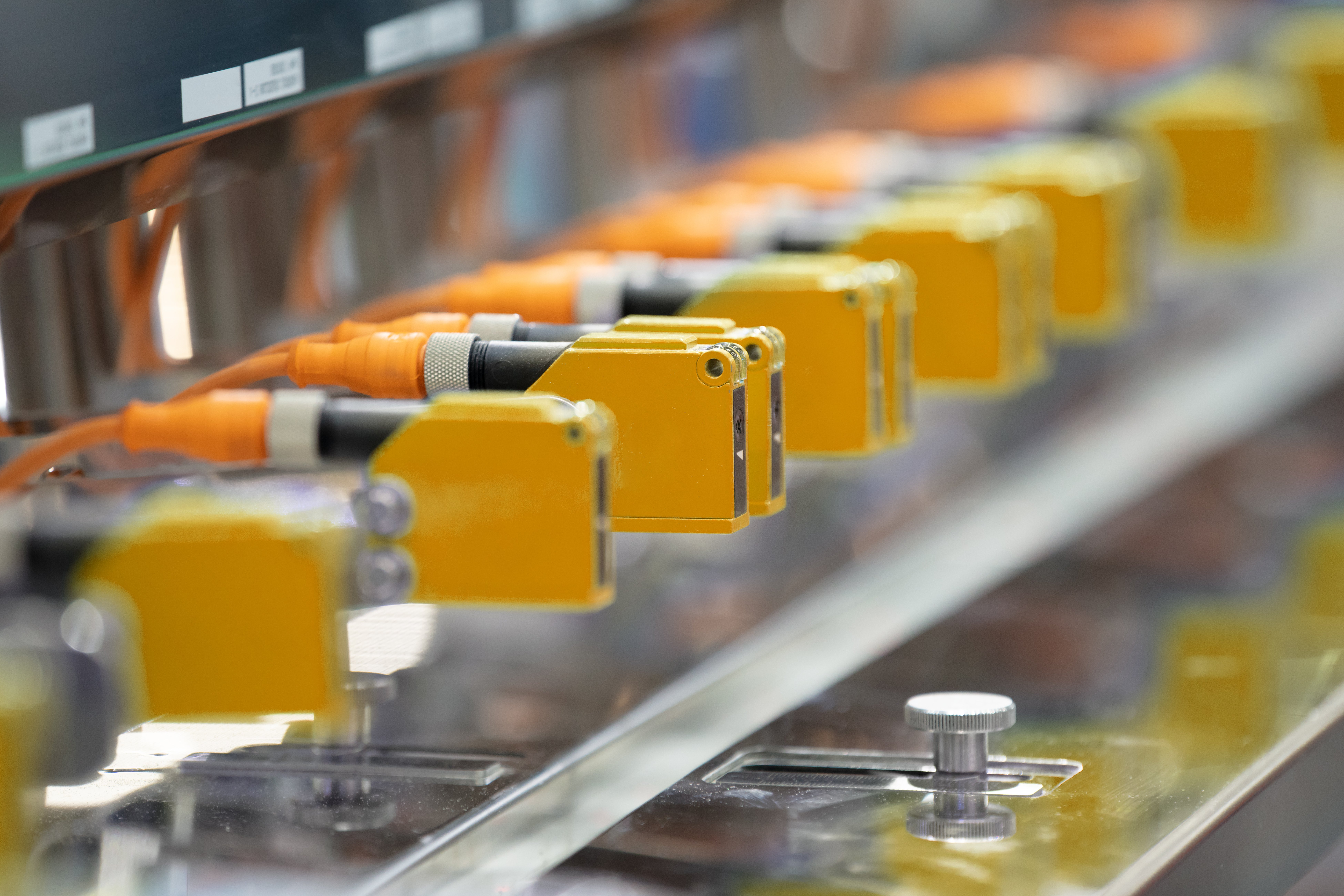 Yellow Photoelectric Sensor installed in a row